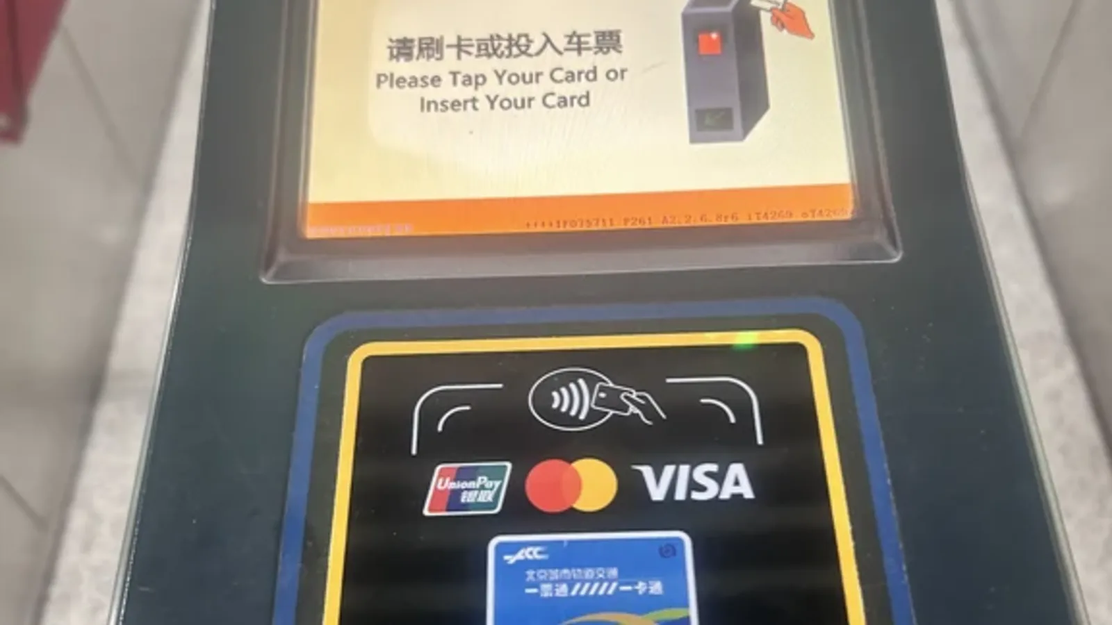 Contactless overseas bank card reader at a Beijing subway gate